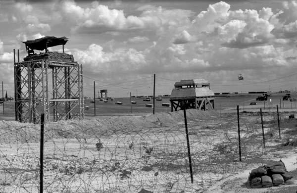 Helicopter, sandbags and barbed wire.